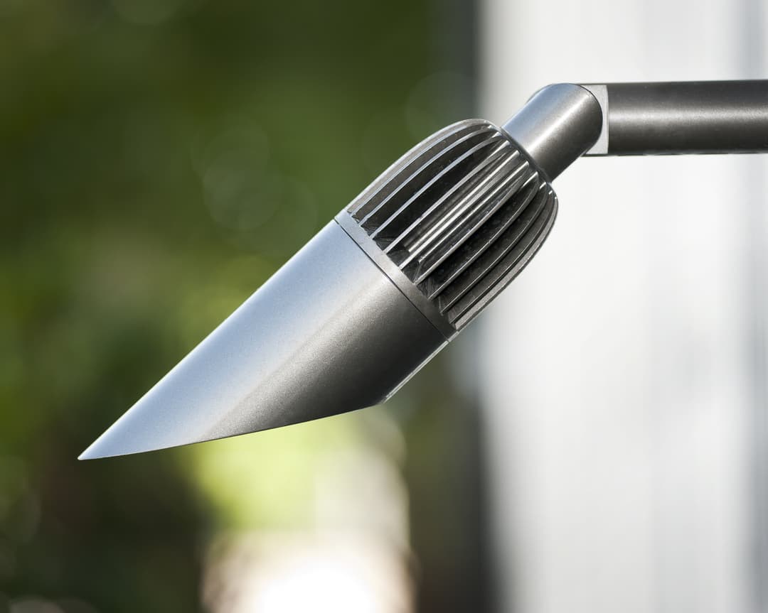 Modern outdoor lighting fixture with sleek metallic finish and unique design.